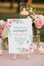 Pastel Floral Unplugged Ceremony sign close-up showing pink blossoms and butterfly detail