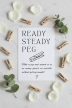 Ready Steady Peg sign flat lay with wooden pegs and eucalyptus