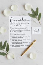 Table Captain's Card flat lay with gold pen and rose petals